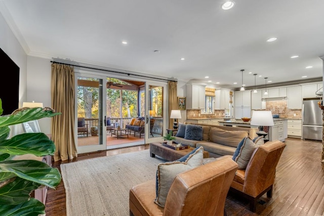 living room featuring crown molding and hardwood / wood-style floors