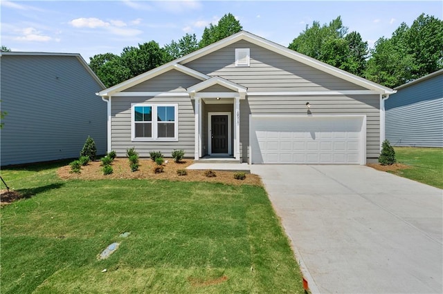 view of front of property with a garage and a front yard