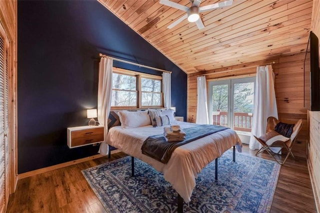 bedroom with lofted ceiling, wood ceiling, multiple windows, and wood finished floors