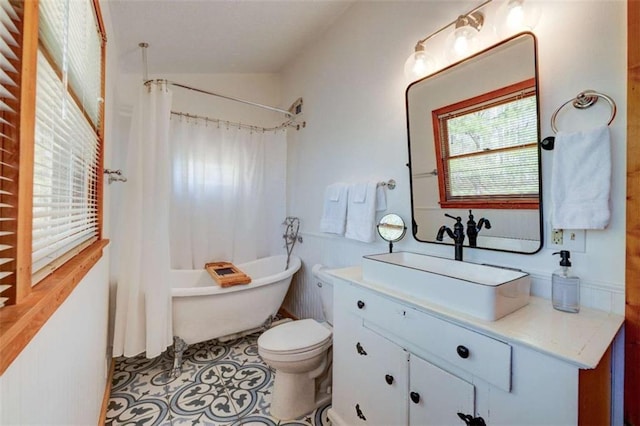 full bath with shower / bath combination with curtain, tile patterned flooring, vanity, and toilet