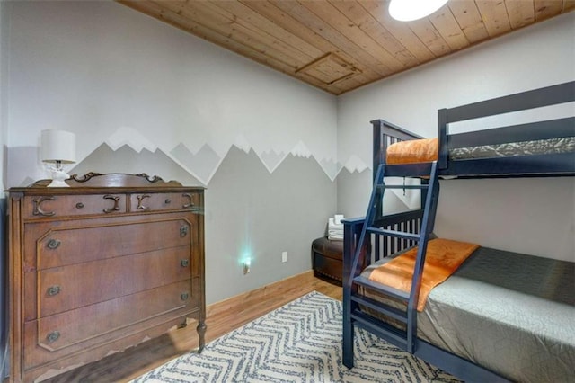 bedroom with light wood-type flooring and wood ceiling