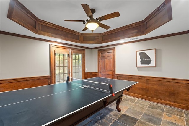 4840 Spring Park Cir, Suwanee, GA 30024 - game room featuring a wainscoted wall, crown molding, a raised ceiling, stone finish flooring, and ceiling fan
