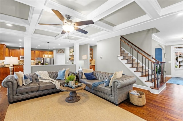 4840 Spring Park Cir, Suwanee, GA 30024 - living area featuring wood finished floors, coffered ceiling, a ceiling fan, stairway, and beamed ceiling