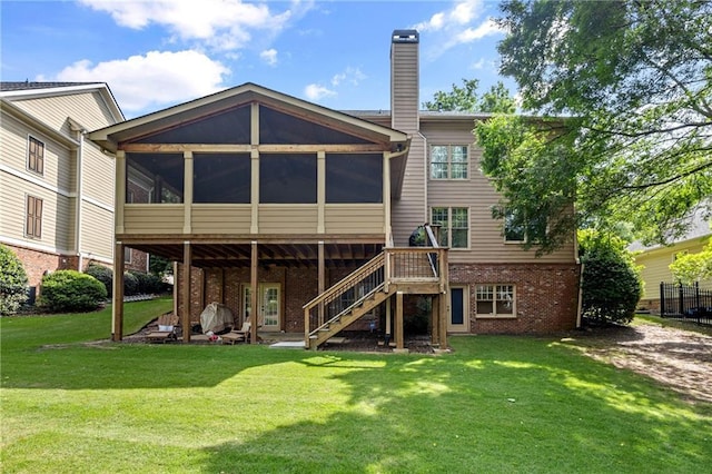 4840 Spring Park Cir, Suwanee, GA 30024 - rear view of house featuring brick siding, a sunroom, stairs, and a yard
