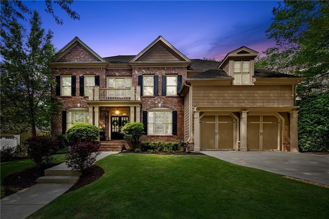 4840 Spring Park Cir, Suwanee, GA 30024 - colonial house with concrete driveway, a lawn, brick siding, and a balcony