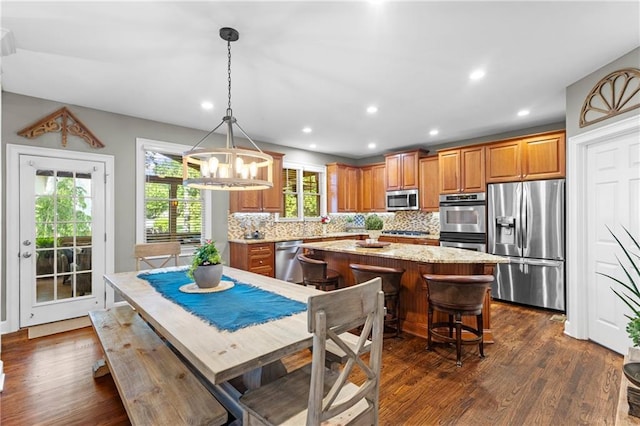 4840 Spring Park Cir, Suwanee, GA 30024 - dining room featuring dark wood-style floors, recessed lighting, and a chandelier