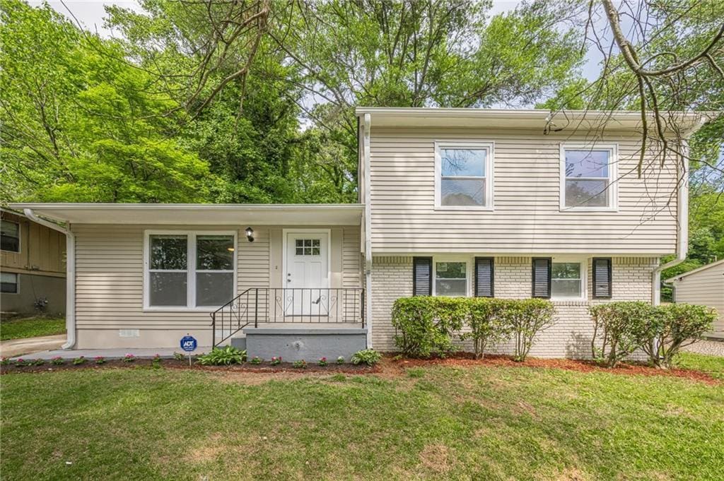 2509 Browns Mill Rd SE, Atlanta, GA 30354 - split level home featuring brick siding and a front yard