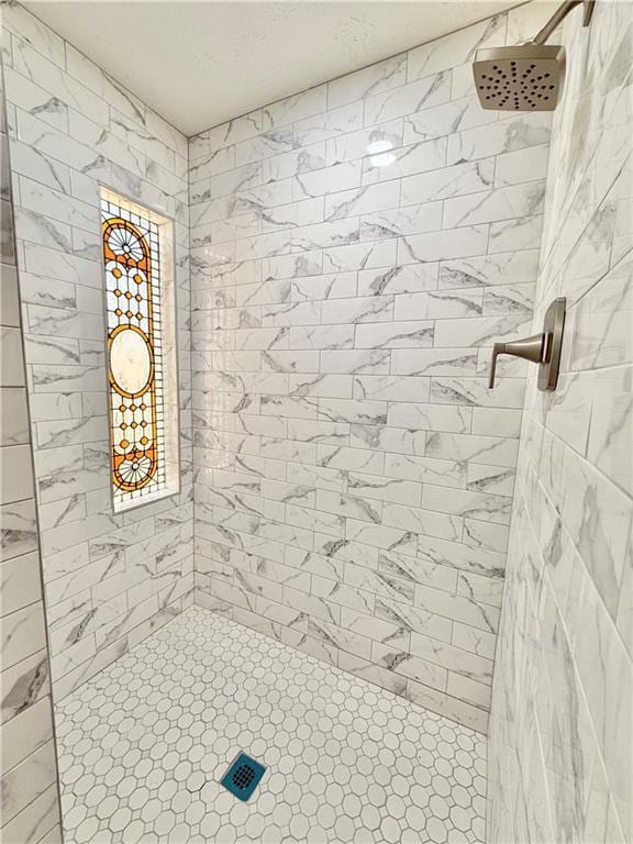 full bath featuring a tile shower