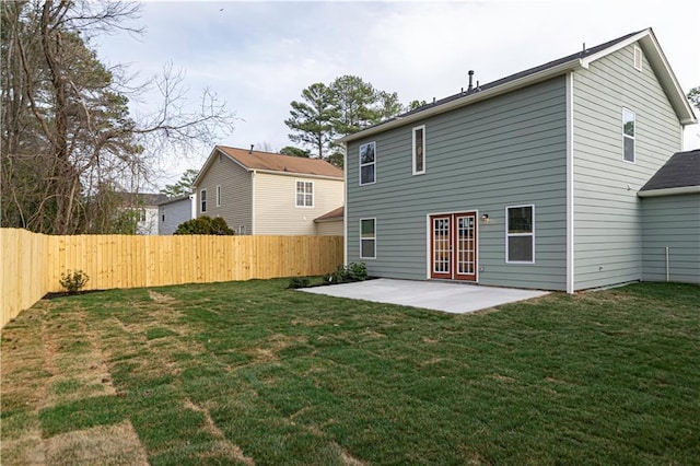 rear view of property with a lawn, a patio area, and a fenced backyard