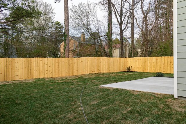 view of yard featuring a patio area and a fenced backyard