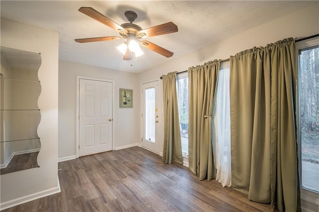 entrance foyer featuring dark wood-type flooring and ceiling fan