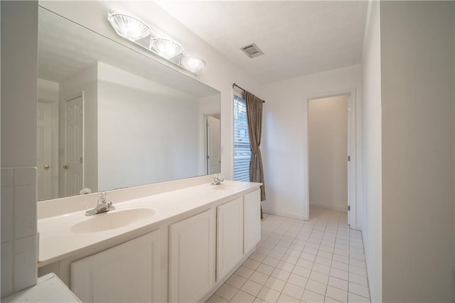 bathroom with vanity and tile patterned flooring