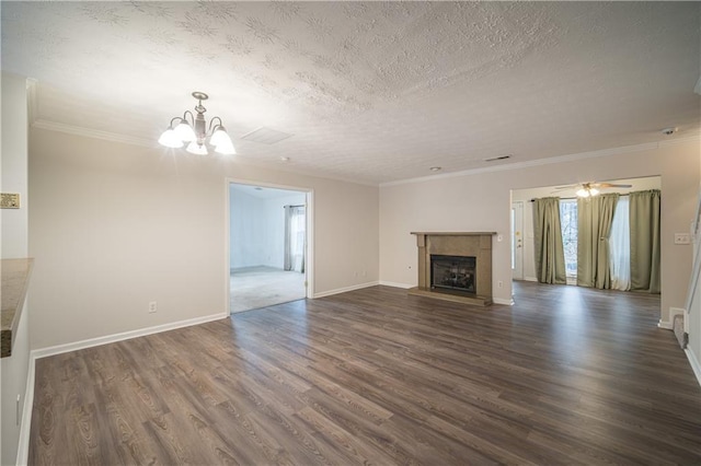 unfurnished living room with crown molding, dark hardwood / wood-style floors, a chandelier, and a textured ceiling