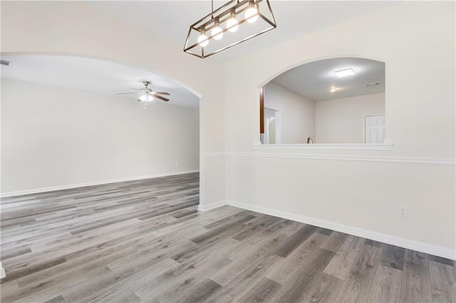2957 Smith Ridge Trce, Peachtree Corners, GA 30071 - spare room with wood finished floors, a ceiling fan, arched walkways, and baseboards