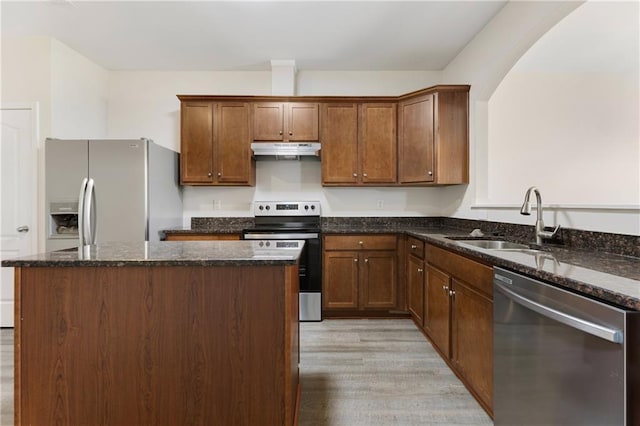 2957 Smith Ridge Trce, Peachtree Corners, GA 30071 - kitchen featuring appliances with stainless steel finishes, under cabinet range hood, a sink, light wood finished floors, and a kitchen island
