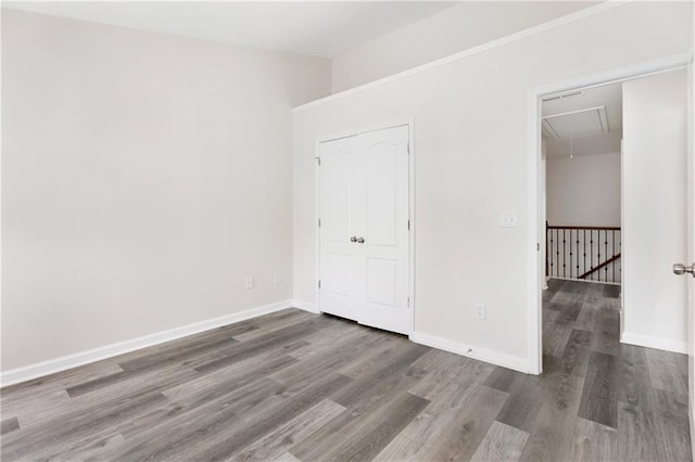 2957 Smith Ridge Trce, Peachtree Corners, GA 30071 - unfurnished bedroom featuring attic access, wood finished floors, and baseboards