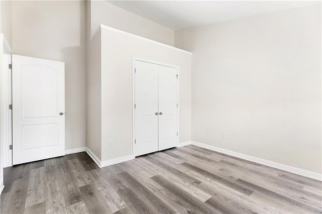 2957 Smith Ridge Trce, Peachtree Corners, GA 30071 - unfurnished bedroom with wood finished floors, baseboards, and a closet