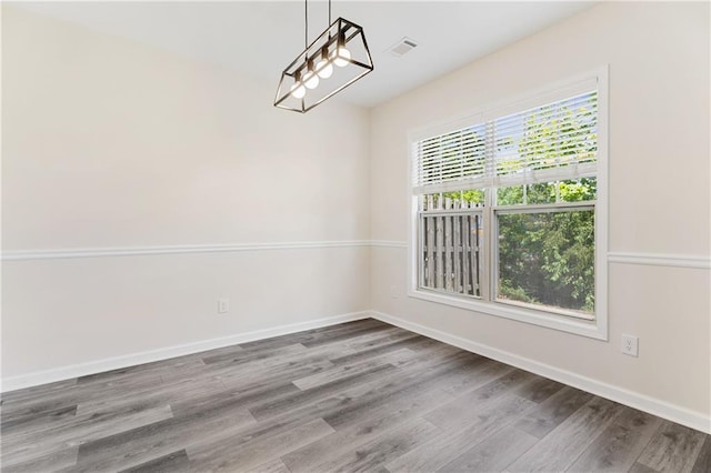 2957 Smith Ridge Trce, Peachtree Corners, GA 30071 - unfurnished dining area featuring wood finished floors, baseboards, and a chandelier