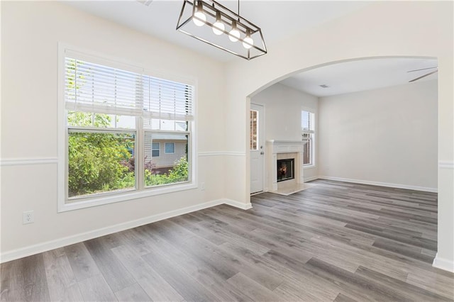 2957 Smith Ridge Trce, Peachtree Corners, GA 30071 - unfurnished living room with plenty of natural light, wood finished floors, baseboards, and arched walkways