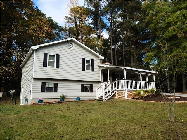 tri-level home featuring a porch and a front yard