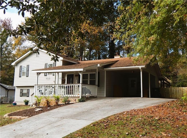 727 Regina Ct, Lawrenceville, GA 30043 - view of front of house with a porch, driveway, an attached carport, and a chimney