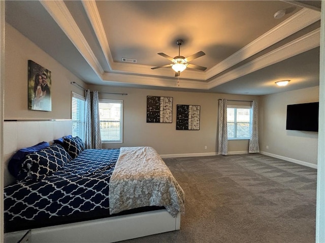 bedroom with visible vents, baseboards, ornamental molding, a tray ceiling, and dark carpet