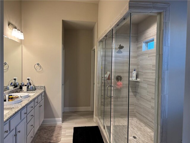 bathroom with vanity and a shower with shower door