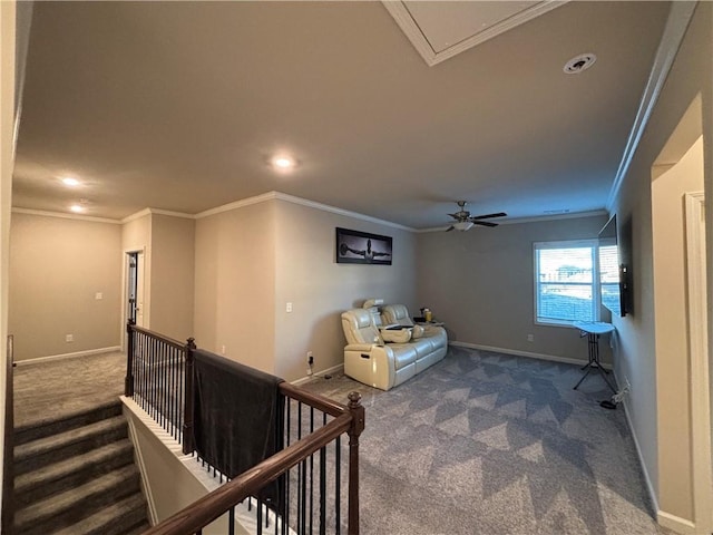 interior space with baseboards, carpet, an upstairs landing, and crown molding