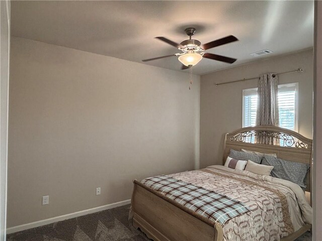 sitting room featuring ceiling fan, ornamental molding, and dark carpet