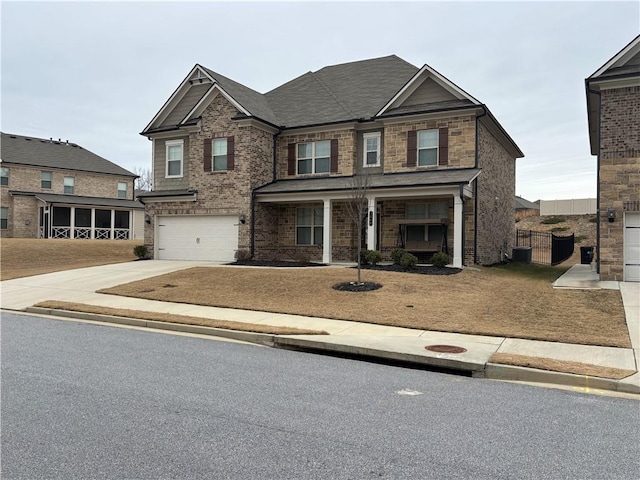 craftsman house featuring a garage, concrete driveway, and brick siding