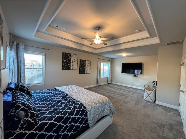 bedroom with dark carpet, baseboards, visible vents, and a raised ceiling