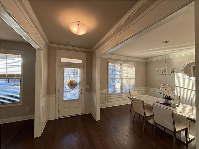 entrance foyer with a wealth of natural light and crown molding