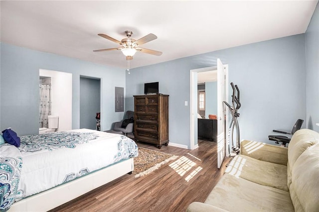 bedroom featuring electric panel, baseboards, ceiling fan, and wood finished floors