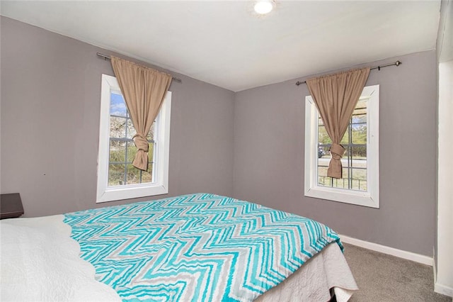 bedroom featuring carpet flooring and baseboards