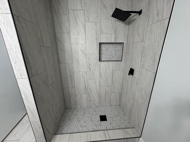 bathroom with tiled shower