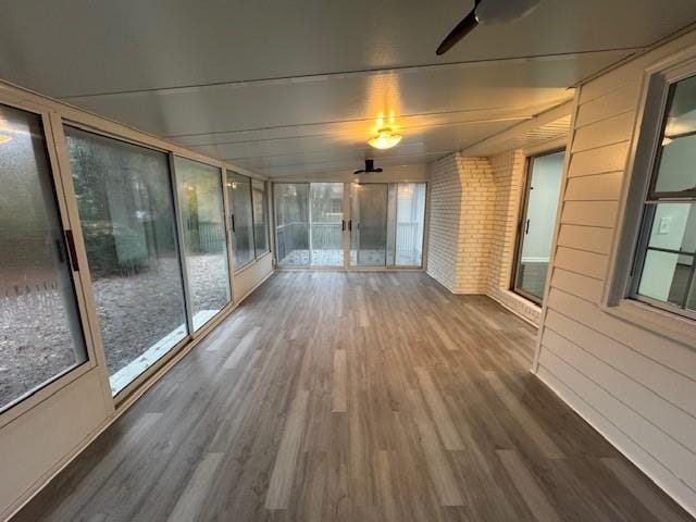 unfurnished sunroom with ceiling fan