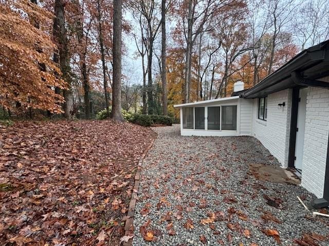 view of yard featuring a sunroom