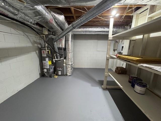 basement featuring heating unit and water heater