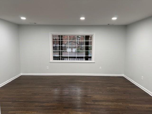 unfurnished room featuring dark wood-type flooring