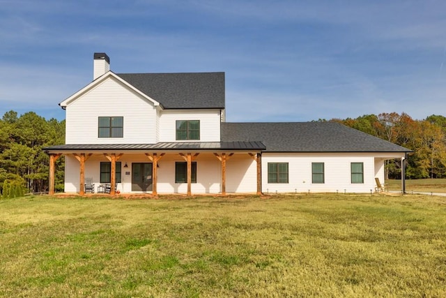 rear view of house with a lawn and a patio