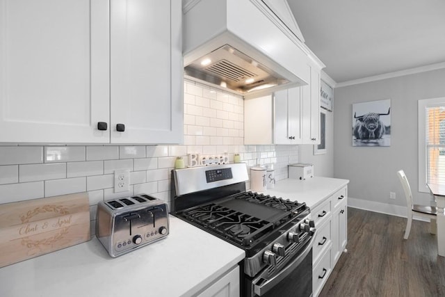 kitchen featuring premium range hood, ornamental molding, white cabinets, dark hardwood / wood-style floors, and stainless steel range with gas cooktop