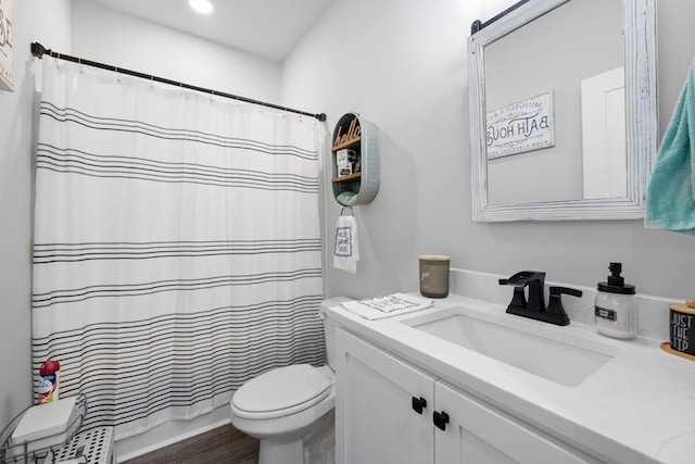 bathroom with curtained shower, vanity, wood-type flooring, and toilet