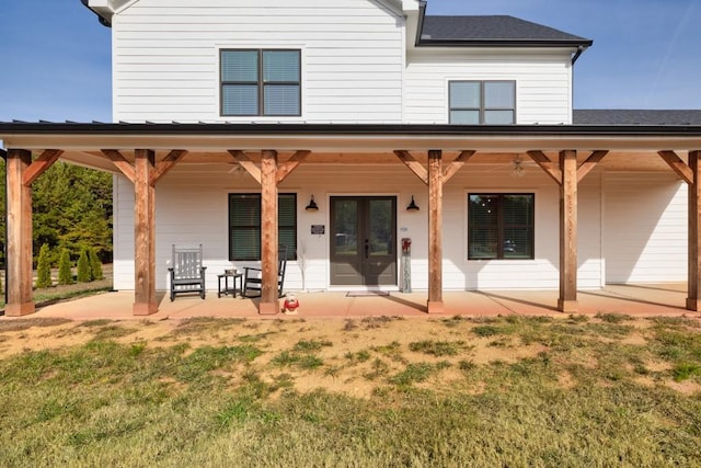 back of house with a lawn and french doors