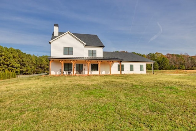 back of house with a lawn and a porch