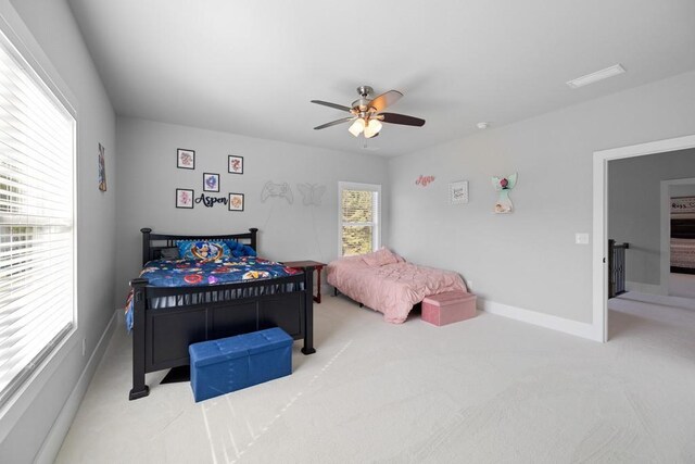 bedroom featuring ceiling fan and light colored carpet