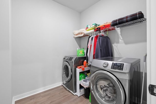 laundry room featuring hardwood / wood-style flooring and independent washer and dryer