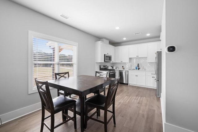 dining area featuring light hardwood / wood-style floors and sink