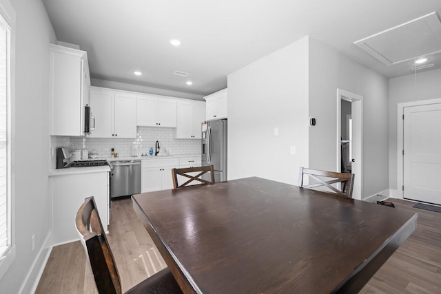 dining area with hardwood / wood-style flooring and sink