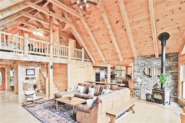 1397 Chestnut Cove Trl, Jasper, GA 30143 - living room featuring a wood stove, high vaulted ceiling, ceiling fan, wood finished floors, and wooden ceiling with exposed beams