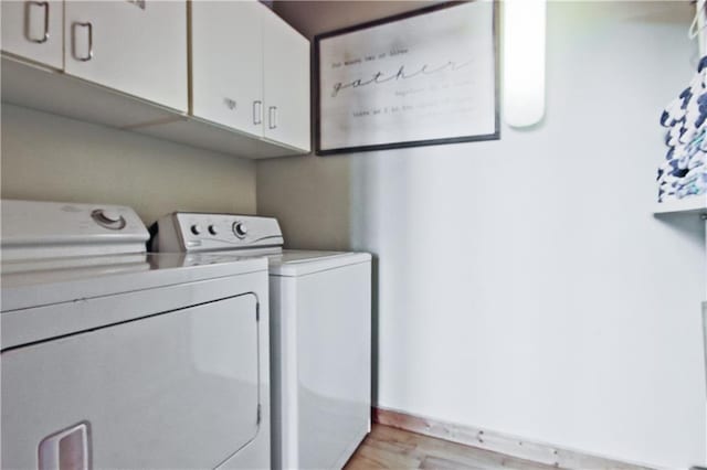 1397 Chestnut Cove Trl, Jasper, GA 30143 - washroom featuring cabinet space, separate washer and dryer, and light wood-type flooring